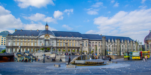 People are walking through place saint lamberts in front of former palace of the prince bishops.