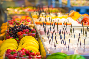 Delicious sweet cocktails and fresh fruits in the shop with