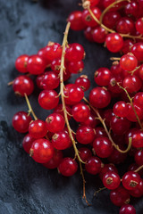 Fresh ripe redcurrant fruit on slate background