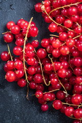 Fresh ripe redcurrant fruit on slate background
