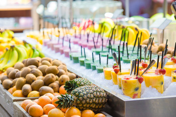 Delicious sweet cocktails and fresh fruits in the shop with