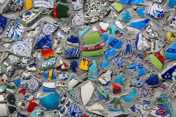 wall with broken ceramic plates colored fragments