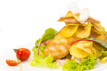 salad with chicken and potatoes on a white plate in a restaurant