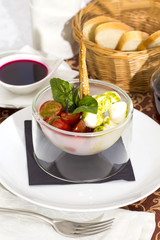 tomatoes and cheese on white plate in a restaurant