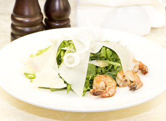 shrimp salad and greens on a white background