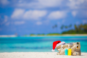 Beach accessories with Santa Hat on white tropical beach