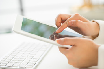 Hands of an office woman typing keyboard with credit card