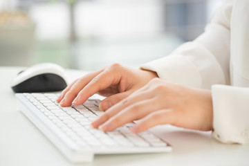 Hands of an office woman typing keyboard with credit card