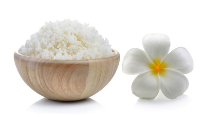 rice in wood bowl and flowers frangipani on white background