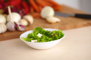 Young woman cutting vegetables in the kitchen
