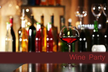 Glass of red wine in bar on blurred background