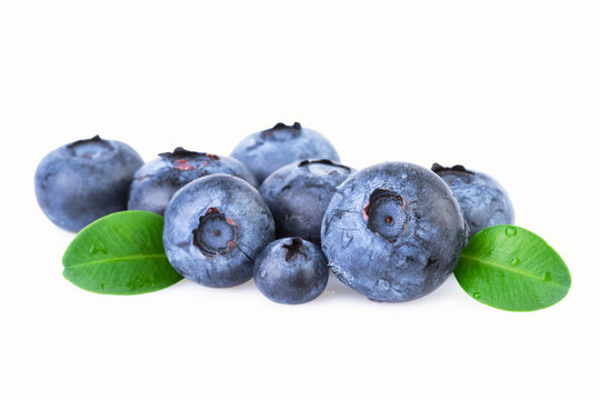Blueberries with green leafs isolated on white
