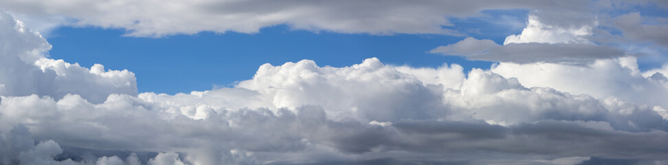 Naklejka na ściany i meble Beautiful blue cloudy sky. Panoramic shot.