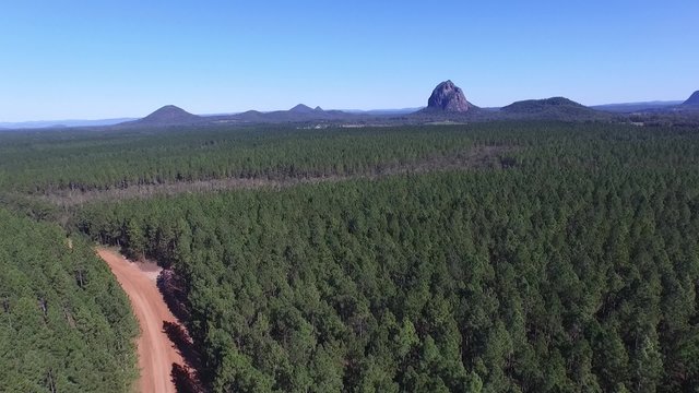 Aerial view video footage of australian glasshouse mountain range on sunshine coast, queensland tourism holiday area.
Featuring mount tibrogargan, mount coonowrin, mt beerwah and mt Tibberoowuccum