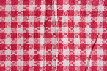 Red picnic tablecloth background, fabric texture.