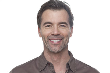 Obraz premium Portrait Of A Mature Man Smiling At The Camera Isolated On White