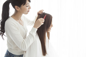 Hairdresser is dissolved a woman's hair with comb
