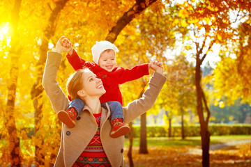 happy family: mother and child little daughter play cuddling on