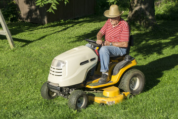 Farmer Cutting His Grass During A Hot Summer Day