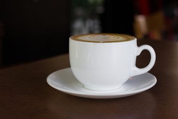 Cup of art latte or cappuccino coffee.