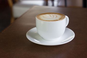 Cup of art latte or cappuccino coffee.