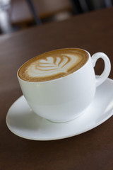 Cup of art latte or cappuccino coffee.