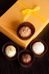 Chocolate handmade candies on a black table. Chocolate box