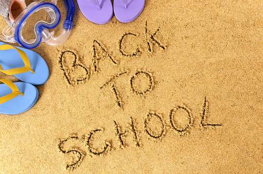 Back to school words written in sand on a tropical beach photo
