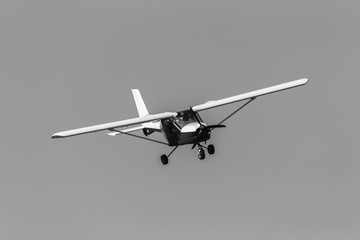 Flying Light Aircraft prop plane in black white vintage