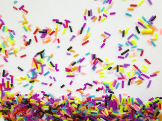 Festive colorful confetti on white background