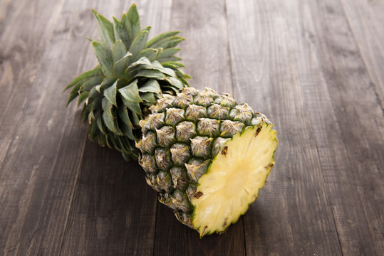 Fresh pineapple on the wooden texture background