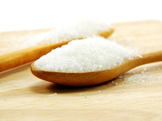 Fototapeta na wymiar sugar in a wooden spoon selective focus