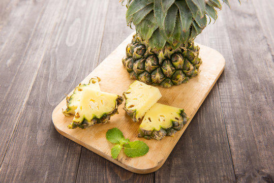 Fresh Yellow Organic Pineapple cut into slices.