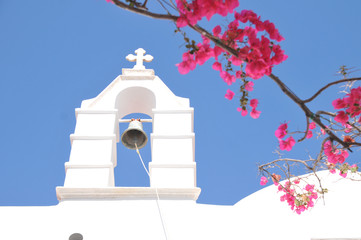Church Bell and pink flowers in Mykonos, Greece