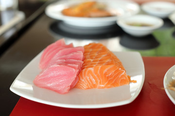salmon and maguro sashimi on white dish.