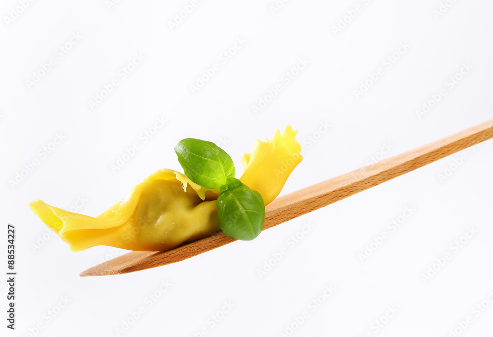 Wall mural Stuffed pasta on wooden spatula