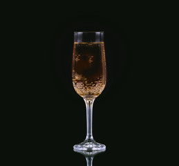 Glass of cold champagne with black background