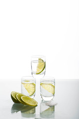 Three shots of vodka with lime
