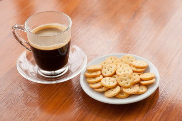 coffee on wood background and biscuits