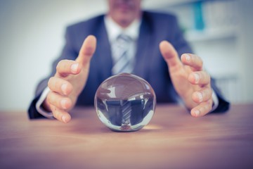 Businessman forecasting a crystal ball