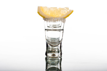 Four shots of vodka with lemon
