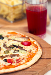 Pizza with meat, tomatoes and olives