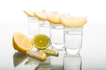 Four shots of vodka with lemon