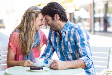  Cute couple sitting at a cafe head to head