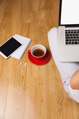 Overhead shot of laptop, tablet, coffee and headphones