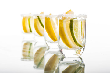 Four shots of vodka with lemon