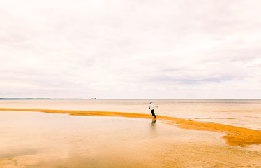Fototapeta na wymiar Boy playing on the shore of the lake