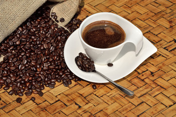 Cup of coffee with spoon and sac