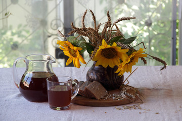  kvass (kvas) on rye ferment and a bouquet from sunflowers
