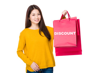 Woman hold with shopping bag showing a word discount